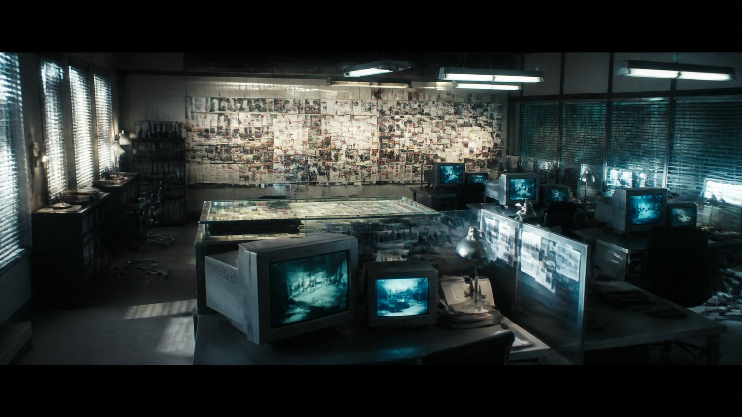 CBI Special Unit — A repurposed open-plan war-room: glass evidence boards, a giant VICTIM / MOVEMENT WALL of photos, red string and maps, banks of CRT and flat monitors at Agyeya’s station, steel desks, fluorescent wash. The nerve centre of the hunt.