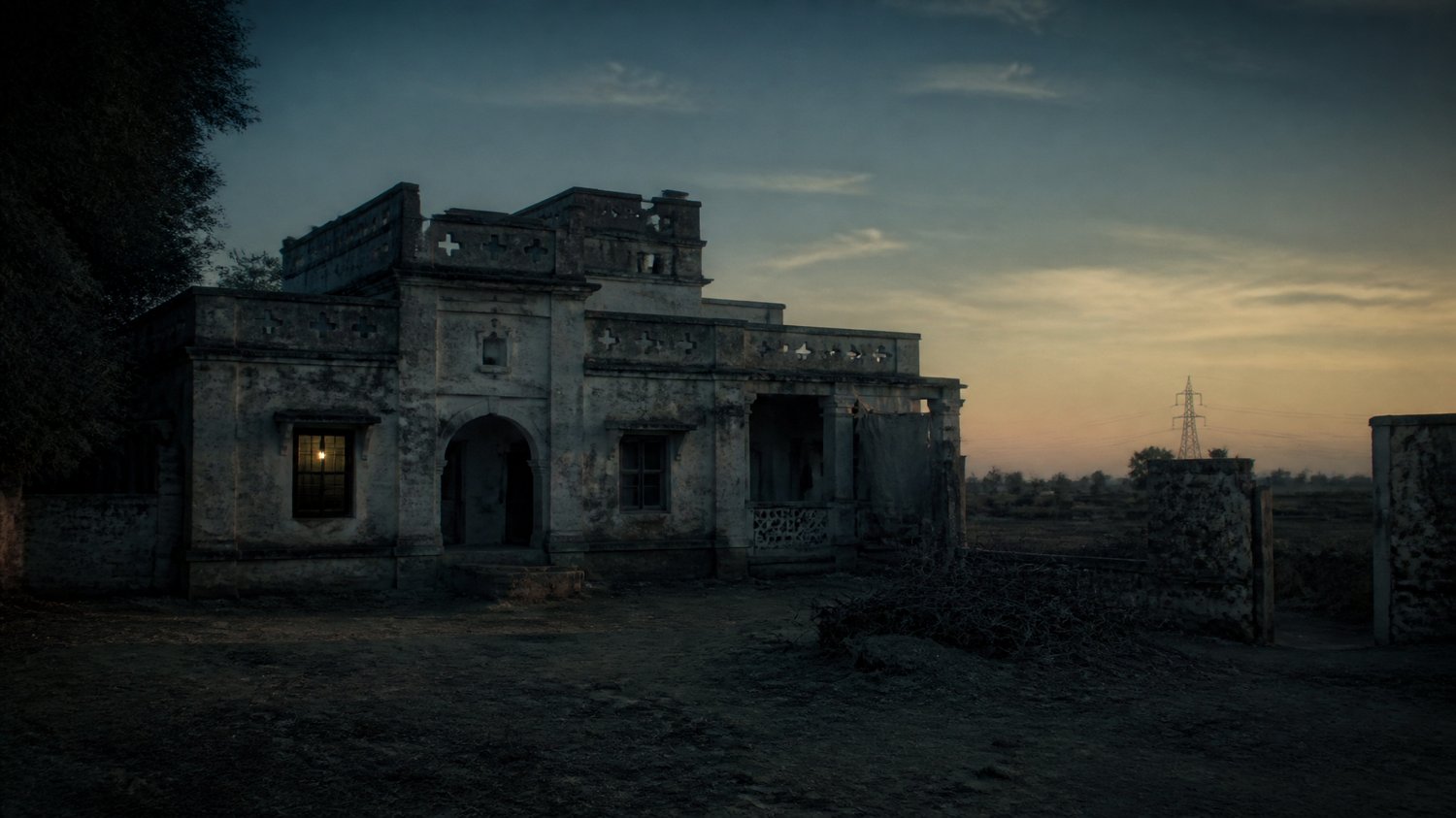 Rajjo Sadan (Exterior) — A crumbling ancestral village house off the GT Road — dust, dry fields, a siege at dusk. Where Satpal ends.